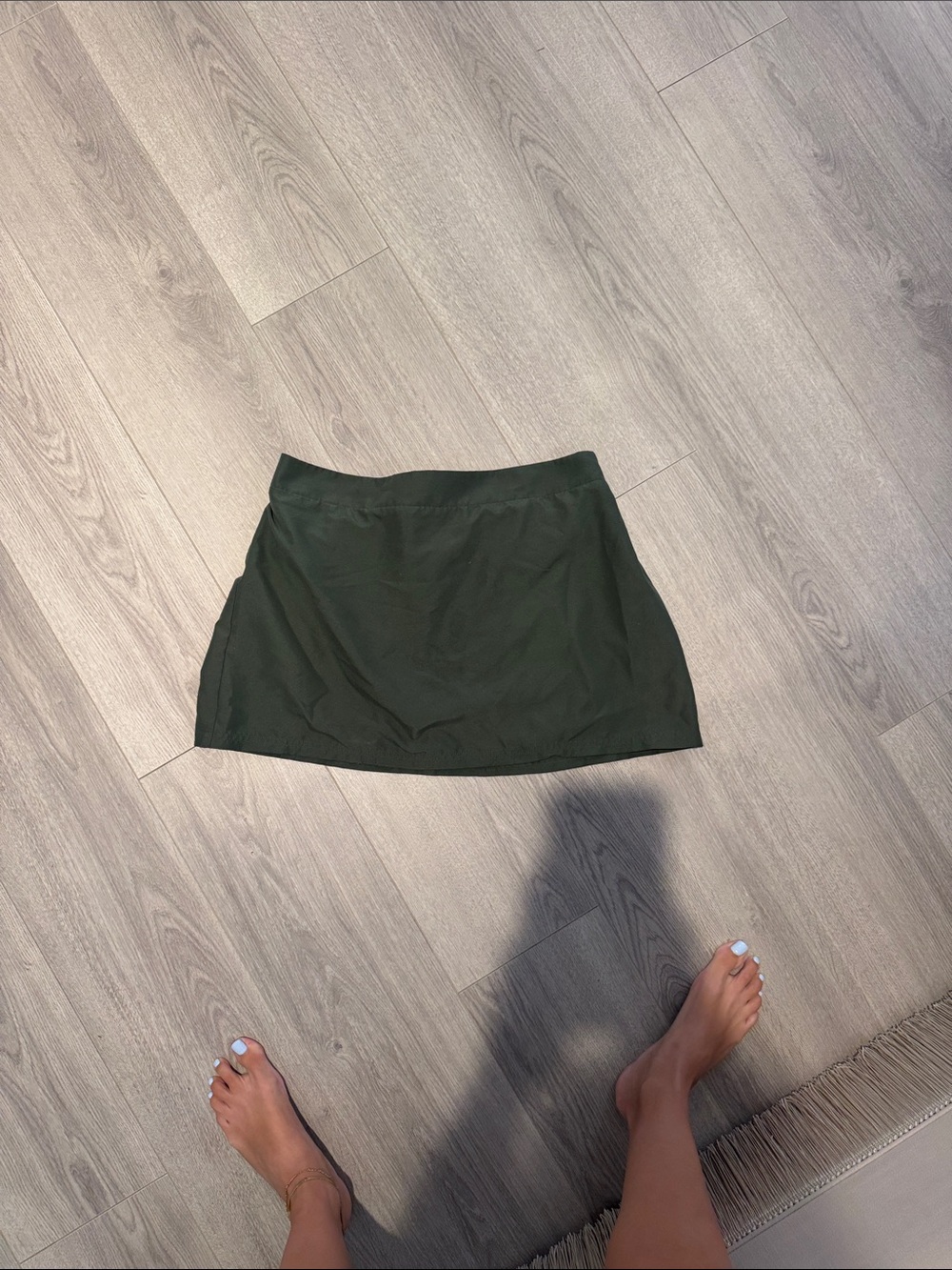 Green pool skirt or active skirt on top of the swim suit in closet
